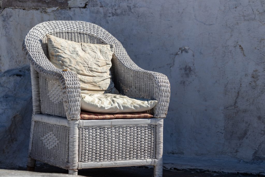 gray wicker armchair with gray cushion pads